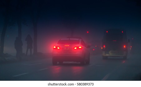 Headlights Of Cars Driving In Fog At Night