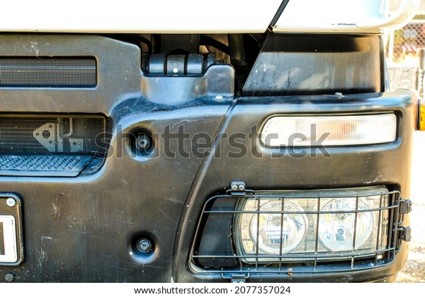 Headlights of\
oversize truck and black\
bodywork