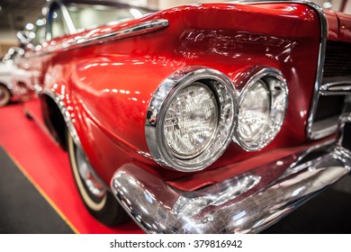Headlights of a red vintage car in a salon - Shutterstock ID 379816942