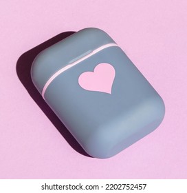 Headphone Case On Pink Background With Hard Shadows