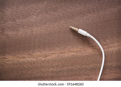 Headphone Jack On The Wooden Background