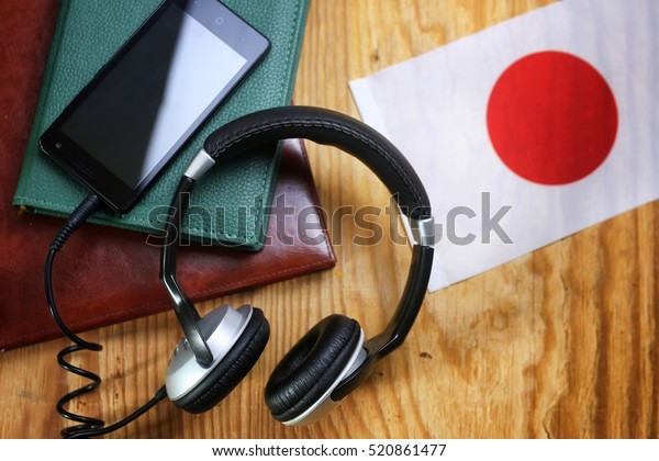 headphones and flag on a wooden background concept\
course language 