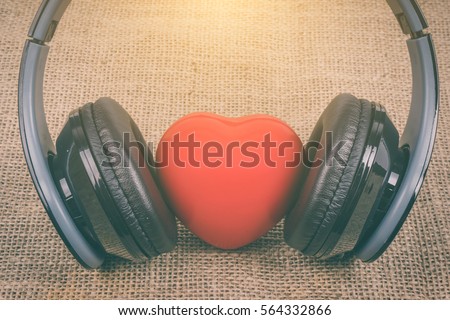 Headphones and heart  on sackcloth background. ,concept for love listening to music ,Listen to your love heart concept. Red valentine heart.