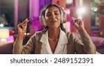 Headphones, Indian woman and night with singing, music and home with audio subscription. Neon, streaming and karaoke with happy, relax and track in a living room and listening to pop song on sofa
