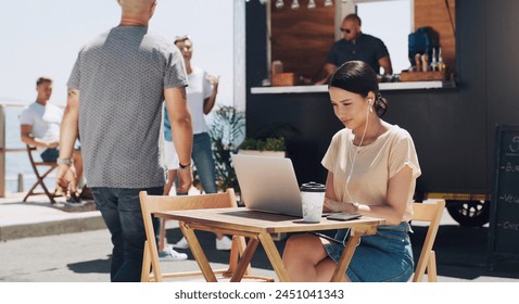 Headphones, laptop and woman at outdoor cafe for remote work, networking or professional research. Earphones, computer and creative freelancer at coffee shop with music, streaming and online project - Powered by Shutterstock