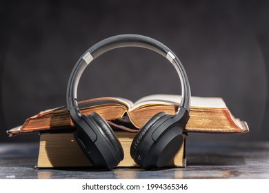 Headphones Lying Next To Old Books. Audiobook Concept