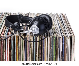 headphones lying on the stack of vinyle records.isolated on white