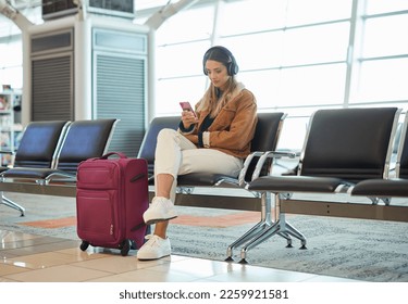 Headphones, music phone and woman in airport lobby on social media, internet browsing or web scrolling. Travel flight, mobile technology and female with smartphone app for streaming radio or podcast. - Powered by Shutterstock