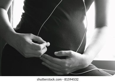 Headphones on a pregnant woman - Powered by Shutterstock