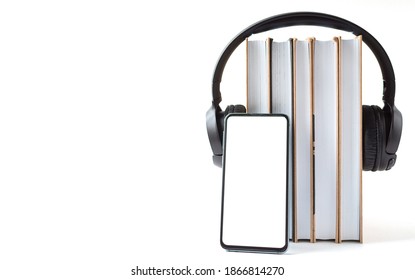 headphones, phone and books on a white background. Audiobook concept