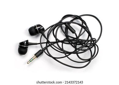Headphones with a tangled wire on a white background. Tangled headphone wire.