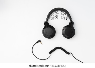 Headphones And Wire Imitating The Face Of A Funny Dude With Musical Notes Instead Of The Brain On The White Background