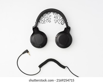 Headphones And Wire Imitating The Face Of A Funny Dude With Musical Notes Instead Of The Brain On The White Background