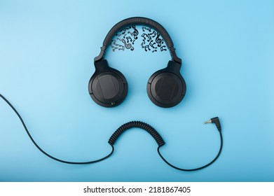 Headphones And Wire Imitating The Face Of A Funny Dude With Musical Notes Instead Of The Brain On The Blue Background