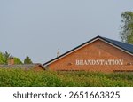 The headquarters of a Danish fire brigade consists of a building on which Brandstation stands, taken near KVAERS in Denmark under hazy skies