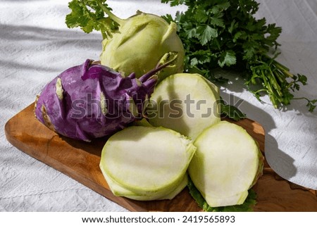 Heads of fresh ripe bio white and purple small cabbage kohlrabi from organic farm, close up