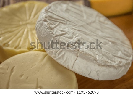 Heads and pieces of cheese, brie masses, mozzarella, suluguni