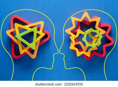 Heads of two people with colourful shapes of abstract brain for concept of idea and teamwork on blue background. Different thinking.	 - Shutterstock ID 2225619255