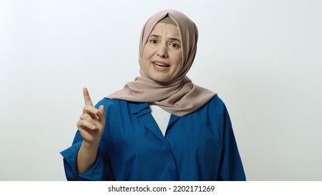 The Headscarved Woman Is Very Angry At What Happened. She Shouts Explaining That He Is Angry. Portrait Of Angry Woman. Indoor Studio Shot Isolated On White Background.