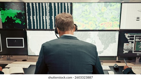 Headset, back or man with screen for maps for news, research or ecology in data center. Pattern, check or computer for tracking technology for meteorology info, storm radar or climate change forecast