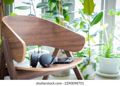 Headset and  portable gaming console lying on the chair at home.