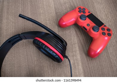Headset and red video game controller.