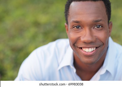 Headshot of a black man smiling