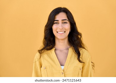 Headshot closeup face portrait of middle eastern Israel girl student isolated on yellow colourful background. Smiling young Arabian Indian woman, businesswoman, business freelancer looking at camera - Powered by Shutterstock