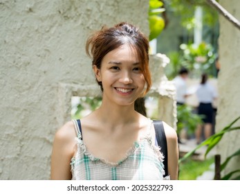 Headshot Close-up Portrait Of Beautiful Young Asian Woman In Cafe, Looking To Camera, Headshot, Feeling Happy Smiling, Smiling Friendly, Candid Portrait, Girl Outdoors, Authentic People.