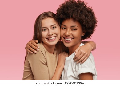 Headshot Of Good Looking Women With Positive Expressions, Cuddle Each Other, Support, Pose For Family Portrait, Model Against Pink Background. People, Emotions And Friendly Relationships Concept