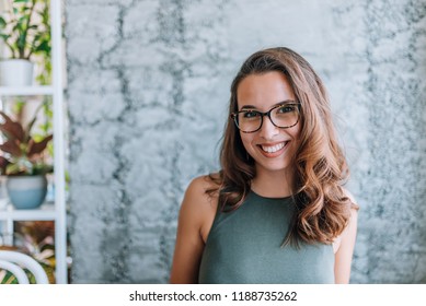 Headshot of gorgeous young woman with eyeglasses.