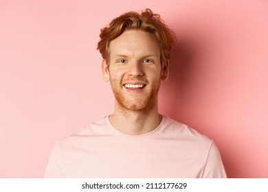 Headshot Of Happy Redhead Man With Beard And White Teeth, Smiling Excited At Camera, Standing Over Pink Background