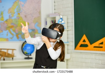 Headshot kills. Virtual classes. VR technology. schoolgirl using virtual reality helmet. Virtual reality headset. Teenager student girl in classroom. Play game. Explore cyber space. Digital world.