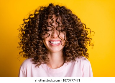 Headshot of laughing cheerful girl with curly hairstyle wearing t-shirt white toothy smile isolated on bright yellow color background