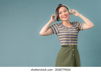 Headshot Of Mature Woman Enjoying Listening To Music With Large Headphones In Studio