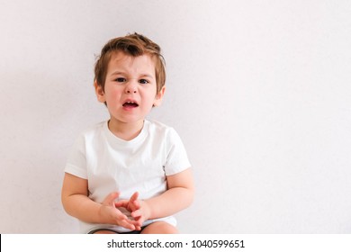 Headshot, Portrait Angry Child Screaming, hands on head isolated grey wall background. Negative Human face Expressions, Emotions, Reaction, life Perception. Conflict, confrontation concept. Behavior