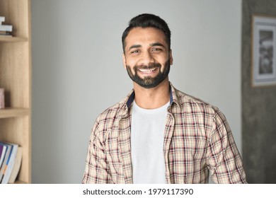 Headshot portrait of attractive confident indian Hispanic man with toothy smile looking at camera at modern living room. Latin businessman posing in casual stylish look at home office. - Shutterstock ID 1979117390