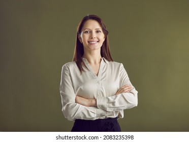Headshot portrait of confident young businesswoman in formalwear isolated on green studio background show leadership qualities. Smiling successful woman employee or boss profile picture.