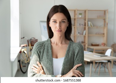 Headshot Portrait Of Confident Young Caucasian Businesswoman Look At Camera Posing In Modern Office, Motivated Millennial European Female CEO Or Boss Show Leadership And Success In Career