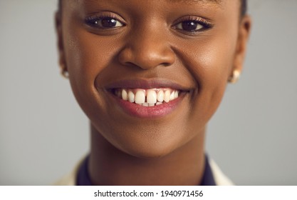 Headshot Portrait Of Happy Glad Pretty Young Black Woman With Nude Makeup, Gap Between Upper Front Teeth And Charming Toothy Smile. Human Face, Women's Beauty, People's Appearance, Dental Care Concept