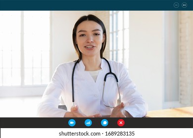 Headshot Portrait Screen Application View Of Positive Female Doctor Consult Client Online On Webcam Conference, Woman Nurse Or A GP In White Uniform Talk On Video Call With Sick Patient At Home