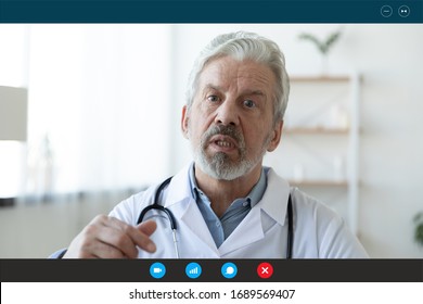 Headshot portrait screen application view of elderly male doctor consult client on computer online, mature man GP talk using video call with sick patient person on Webcam conference on laptop