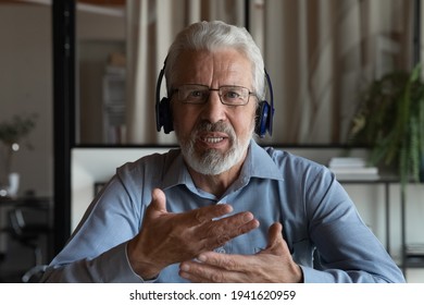 Headshot portrait screen view of middle-aged Caucasian male employee in headphones talk speak on video call in office. Senior businessman have webcam digital conference online. Virtual event concept. - Powered by Shutterstock