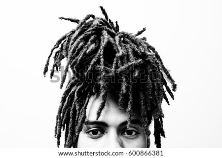 headshot portrait showing only top half of teenager's face with dreadlocks