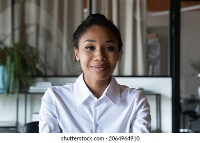 Headshot Portrait Of Smiling Confident Young Asian Businesswoman Look At Camera Hold Remote Job Interview By Video Call. Positive Millennial Mixed Race Business Lady Take Part In Online Web Conference