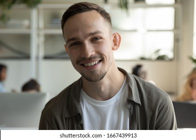 Headshot Portrait Of Smiling Millennial Male Employee Talk On Video Call Or Web Conference In Coworking Office, Profile Picture Of Happy Caucasian Young Man Worker Posing In Shared Workplace