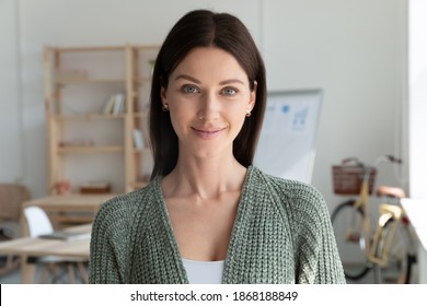 Headshot Portrait Of Smiling Young 20s Businesswoman Stand Posing In Modern Office. Profile Picture Of Happy Female Employee Or Worker Show Leadership And Success At Workplace. Employment Concept.