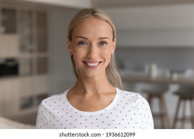 Headshot Portrait Of Smiling Young 20s Caucasian Woman Renter Or Tenant Pose In Living Room In New Home. Close Up Profile Picture Of Happy Millennial Female In Own House. Rental, Employment Concept.