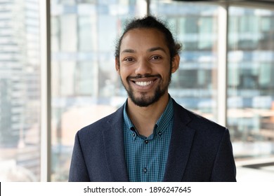 Headshot Portrait Of Smiling Young African American Businessman In Suit Pose In Own Modern Office. Profile Picture Of Happy Successful Male Boss Or CEO In Formalwear Show Confidence And Leadership.