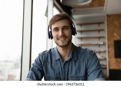 Headshot Portrait Of Smiling Young Caucasian Man In Earphones Talk Speak On Video Call Online With Client. Screen View Of Happy Male In Headphones Have Webcam Conference. Virtual Event Concept.